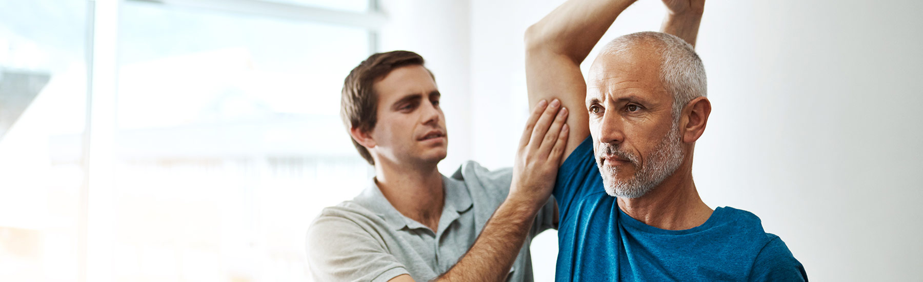 Physio treating a patient's shoulder