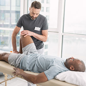 Physiotherapist working on a patient's knee